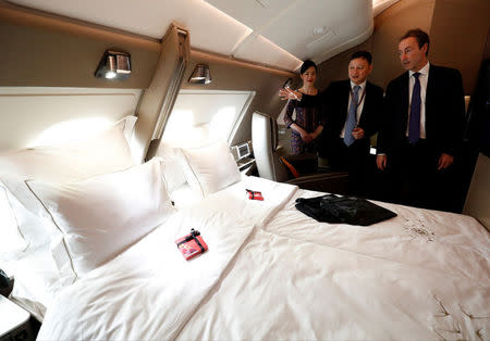 Airbus Chief Operating Officer Fabrice Bregier and Singapore Airlines CEO Goh Choon Phong take a tour of the newly launched Suites cabin on a Singapore Airlines' A380 at Changi Airport in Singapore December 14, 2017. REUTERS/Edgar Su