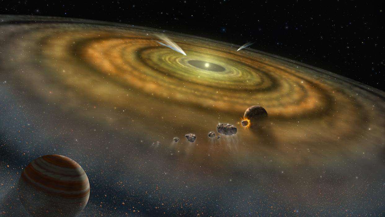  Yellowish rings of gas are seen around a tiny star. Planets and rocks float in the rings. 