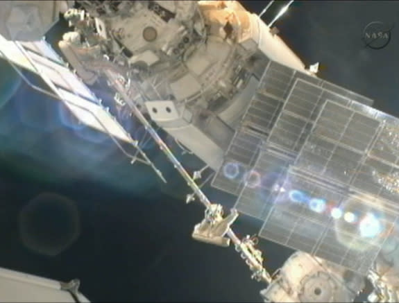 Cosmonauts Gennady Padalka (left) and Yuri Malenchenko work to move a crane outside the International Space Station during a spacewalk on Aug. 20, 2012, in this still image from a video camera on the station.