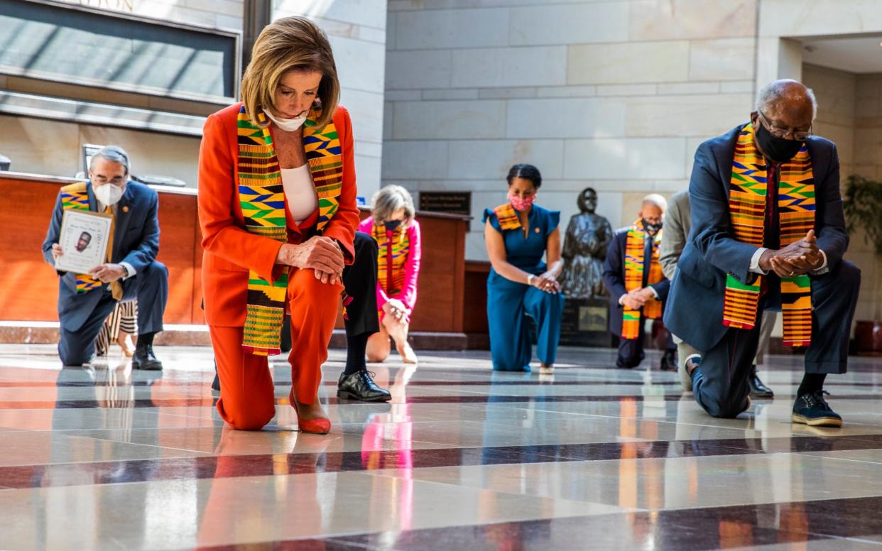 Nancy Pelosi, the Democratic House speaker in red, was among those kneeling - AP Photo/Manuel Balce Ceneta
