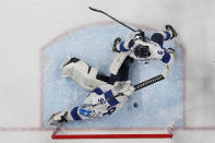 A shot by United States' Cayla Barnes gets past Finland goalkeeper Anni Keisala (36) and Jenni Hiirikoski (6) for a score during a women's semifinal hockey game at the 2022 Winter Olympics, Monday, Feb. 14, 2022, in Beijing. (AP Photo/Petr David Josek)