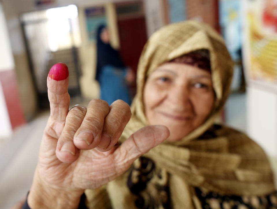 An Egyptian voter displays her inked finger after she cast her ballot on constitutional amendments during the second day of three-day voting at polling station in Cairo, Egypt, Sunday, April 21, 2019. Egyptians are voting on constitutional amendments that would allow President Abdel-Fattah el-Sissi to stay in power until 2030.(AP Photo/Amr Nabil)