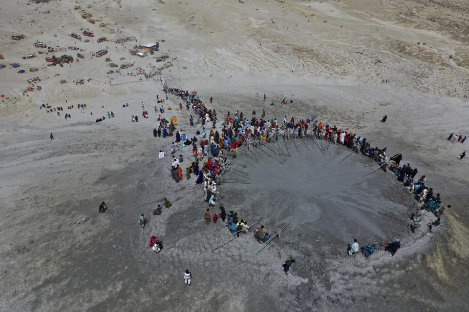 In this aerial photo taken from a drone, Hindu devotees climb stairs to reach on top of a mud volcano to start Hindu pilgrims religious' rituals for an annual festival in an ancient cave temple of Hinglaj Mata in Hinglaj in Lasbela district in Pakistan's southwestern Baluchistan province, Friday, April 26, 2024. More than 100,000 Hindus are expected to climb mud volcanoes and steep rocks in southwestern Pakistan as part of a three-day pilgrimage to one of the faith's holiest sites. (AP Photo/Mohammad Farooq)
