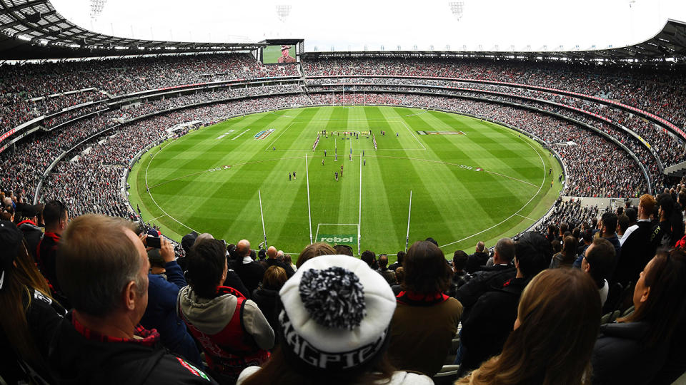 The crowd, pictured here standing for the Last Post during the Anzac Day clash between Collingwood and Essendon.