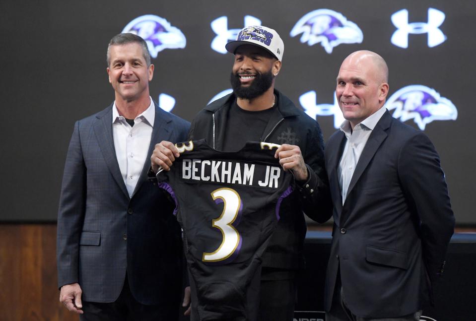 Baltimore Ravens wide receiver Odell Beckham Jr., center, stands with head coach John Harbaugh, left, and general manager Eric DeCosta during a news conference at the team's practice facility.