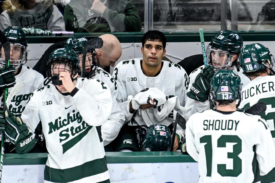 Michigan State senior and leading goal scorer Jagger Joshua, center, looks on from the bench during the third period of the Spartans' win against Michigan earlier this season. The Spartans play their final scheduled home game at Munn Ice Arena against Michigan on Friday night.