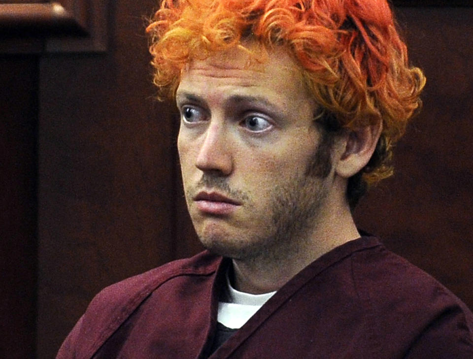 FILE - In this July 23, 2012, file photo, James Holmes, who was convicted of killing 12 moviegoers and wounding 70 more in a shooting spree in a crowded theatre in 2012, sits in Arapahoe County District Court in Centennial, Colo. Prosecutors say several victims of the shootings have filed complaints alleging the state corrections department violated their rights by refusing to reveal where the gunman is serving his life sentence. Prison officials quietly transferred James Holmes to an out-of-state prison in January. (RJ Sangosti/The Denver Post via AP, Pool, File)