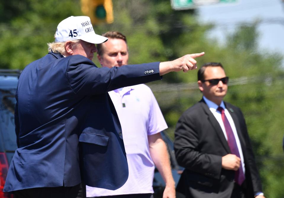 President Donald Trump greets supporters after leaving Trump National Golf Club in Bedminster, New Jersey, on July 26. (NICHOLAS KAMM via Getty Images)