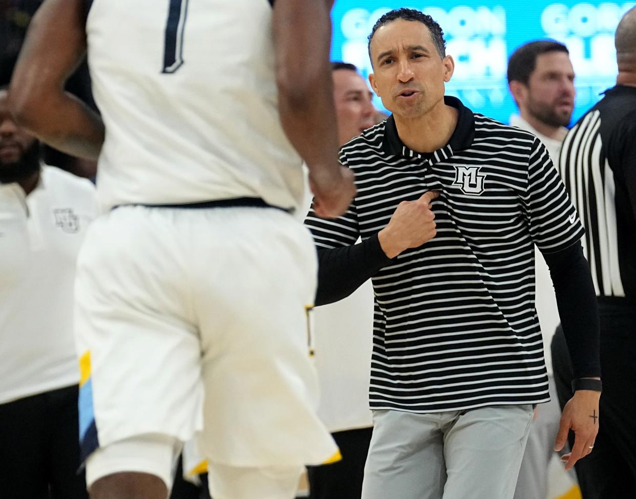 Marquette head coach Shaka Smart talks to guard Kam Jones during the first half of their game against Creighton on Saturday.