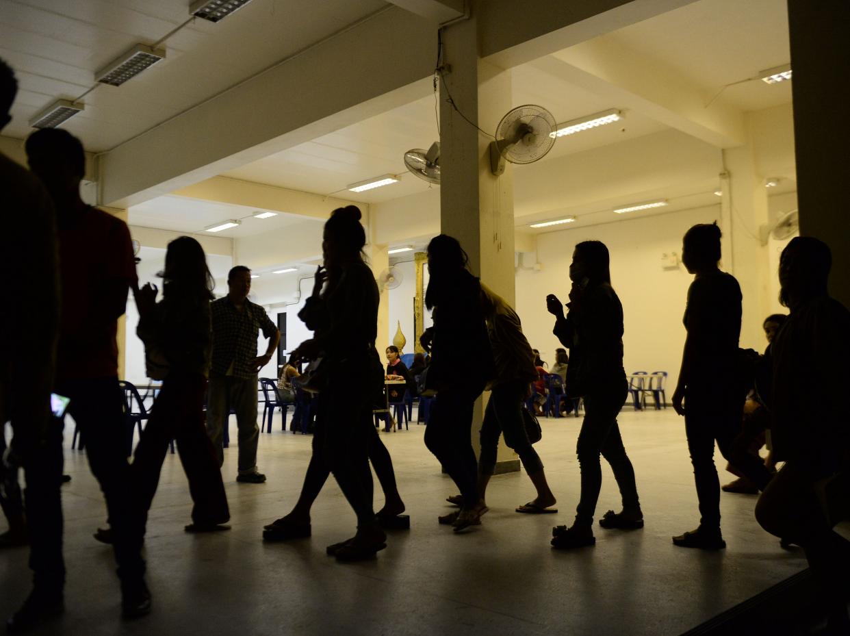 A group of foreign women rounded up by police from karaoke bars in Thailand's southern province of Narathiwat are taken to city hall during a campaign against prostitution and human trafficking involving women and minors on November 9, 2018. - About 50 Laotian women were rounded up by authorities for investigation. (Photo by Madaree TOHLALA / AFP) (Photo credit should read MADAREE TOHLALA/AFP via Getty Images)