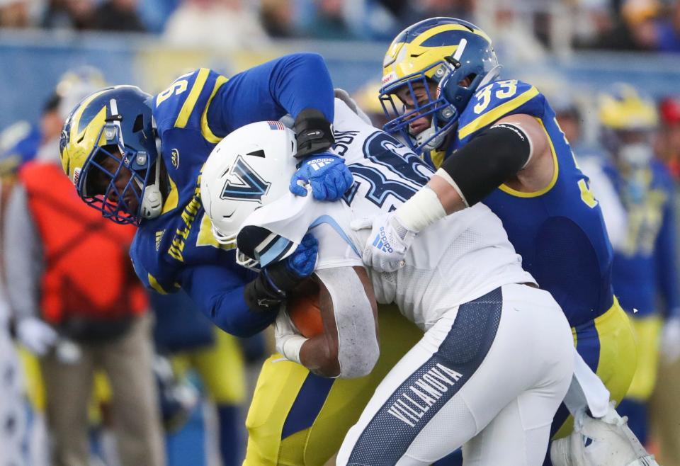 Delaware's Frank Burton (left) and Johnny Buchanan stop Villanova's Jalen Jackson in the fourth quarter of the Blue Hens' 21-13 loss at Delaware Stadium, Saturday, Nov. 20, 2021.