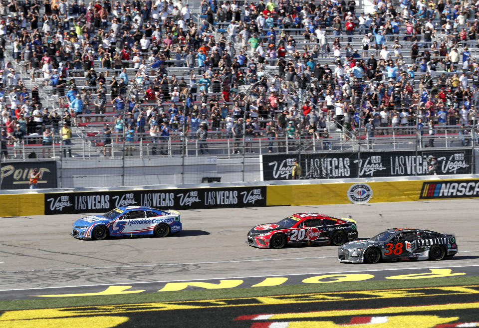 Kyle Larson (5) finishes ahead of Christopher Bell (20) and Zane Smith (38) to win NASCAR Cup Series auto race, Sunday, Oct. 15, 2023, in Las Vegas. (AP Photo/Steve Marcus)