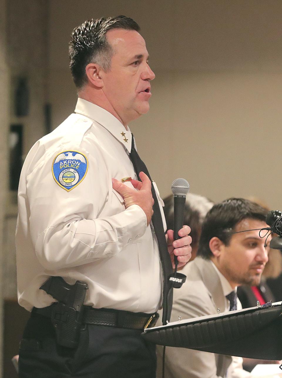 Acting Police Chief Brian Harding talks about the return of name tags for officers during a city of Akron news conference Thursday at the Ocasek Auditorium.