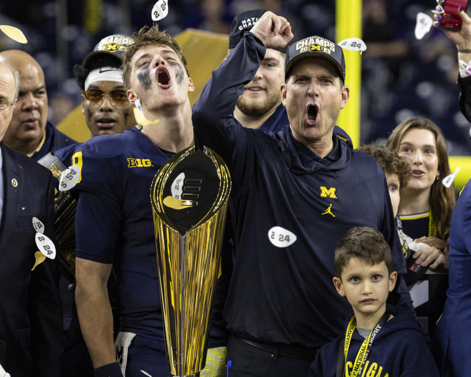 HOUSTON, TX - JANUARY 08: Head Coach Jim Harbaugh and J.J.McCarthy #9 of the Michigan Wolverines celebrate during the trophy presentation after the CFP National Championship between University of Washington and University of Michigan at NRG Stadium on January 8, 2024 in Houston, Texas. (Photo by Steve Limentani/ISI Photos/Getty Images)