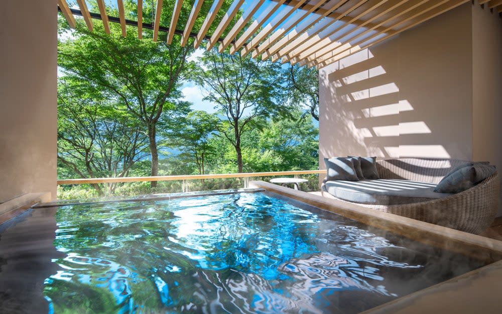 Each bedroom balcony at KAI Sengokuhara in Hakone has its own wooden bath filled with steaming onsen water - akifumi yamabe