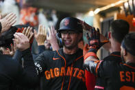 San Francisco Giants' Blake Sabol is congratulated after his two-run home run against San Diego Padres during the seventh inning of a baseball game at Alfredo Harp Helu Stadium in Mexico City, Saturday, April 29, 2023. (AP Photo/Fernando Llano)