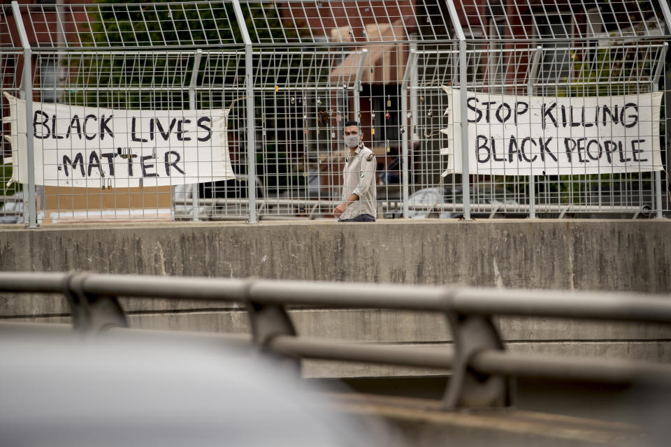 Signs that read "Black Lives Matter" and "Stop Killing Black People" hang on an overpass on North Capitol Street in Washington, Tuesday, June 2, 2020, following days of continuing protests over the death of George Floyd. Floyd died after being restrained by Minneapolis police officers. (AP Photo/Andrew Harnik)