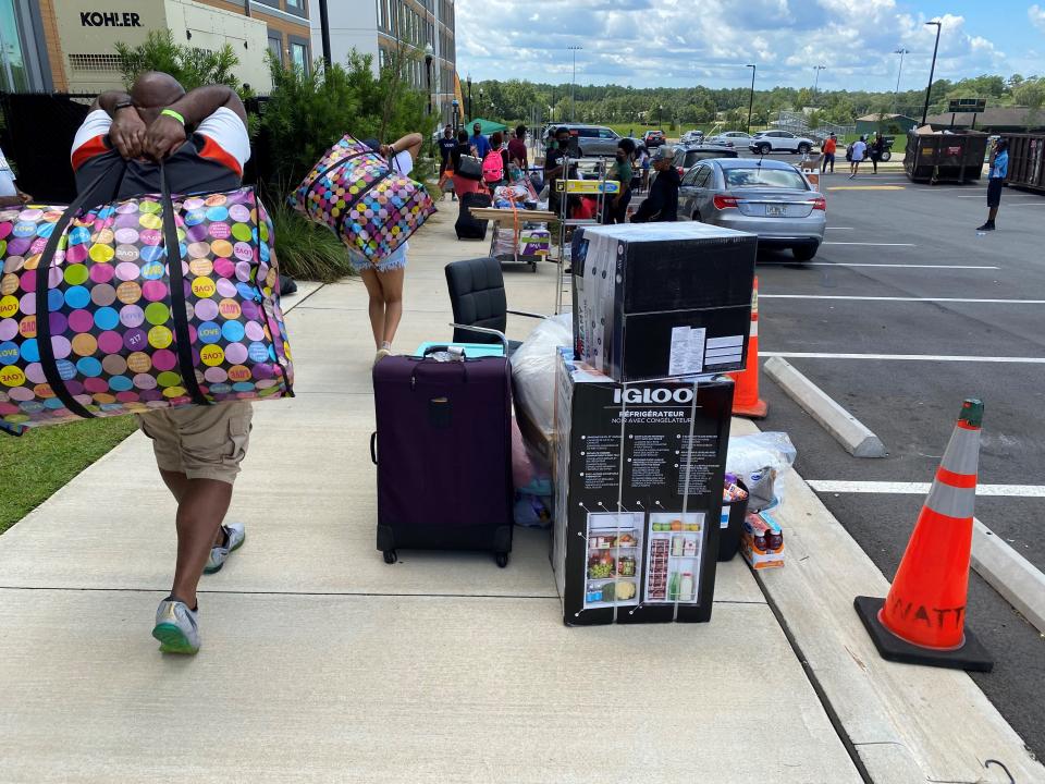 Students and parents unload items as freshmen begin moving into the FAMU Towers North on Tuesday, Aug. 17, 2021, at Florida A&M University.