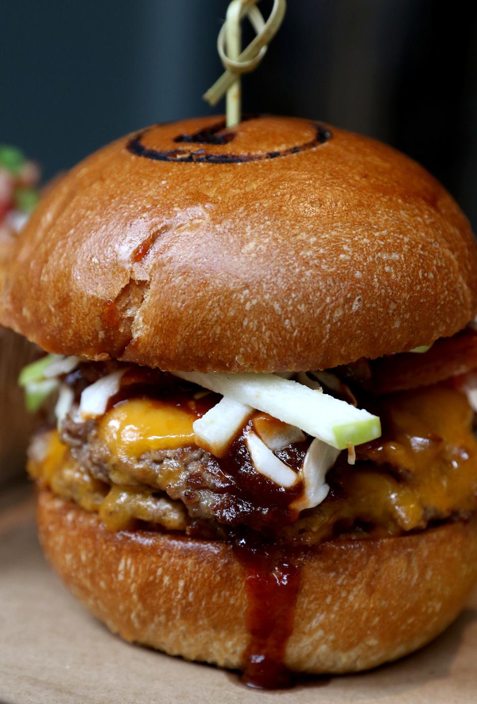The whisky bacon burger with whisky barbecue sauce and apple slaw by Nation Kitchen + Bar.