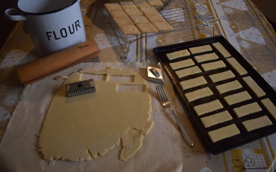 Pastry on pastry sheet with rolling pin and cookie cutters