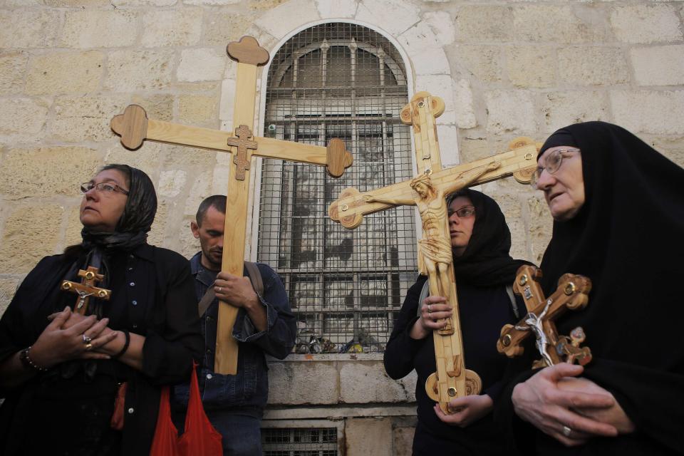 Christian worshippers hold crosses during a procession along the Via Dolorosa on Good Friday during Holy Week in Jerusalem's Old City April 18, 2014. Christian worshippers on Friday retraced the route Jesus took along Via Dolorosa to his crucifixion in the Church of the Holy Sepulchre. Holy Week is celebrated in many Christian traditions during the week before Easter.