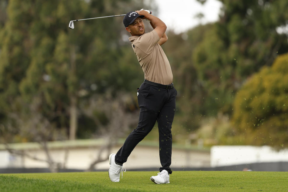 Xander Schauffele his from the first tee during the final round of the Genesis Invitational golf tournament at Riviera Country Club, Sunday, Feb. 18, 2024, in the Pacific Palisades area of, Los Angeles. (AP Photo/Ryan Kang)