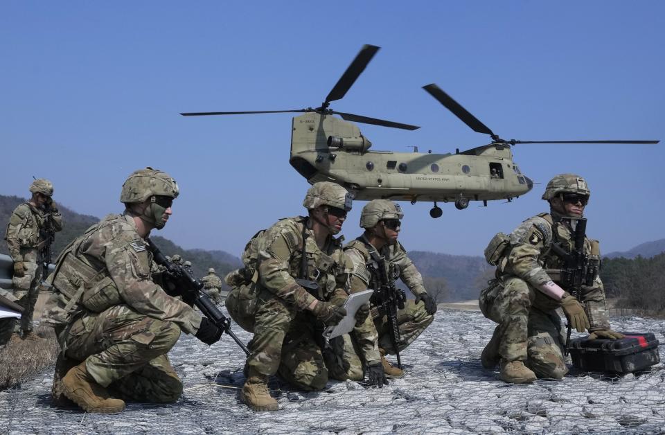 U.S. Army soldiers wait to board their CH-47 Chinook helicopter during a joint military drill between South Korea and the United States at Rodriguez Live Fire Complex in Pocheon, South Korea, Sunday, March 19, 2023. (Ahn Young-joon/AP)