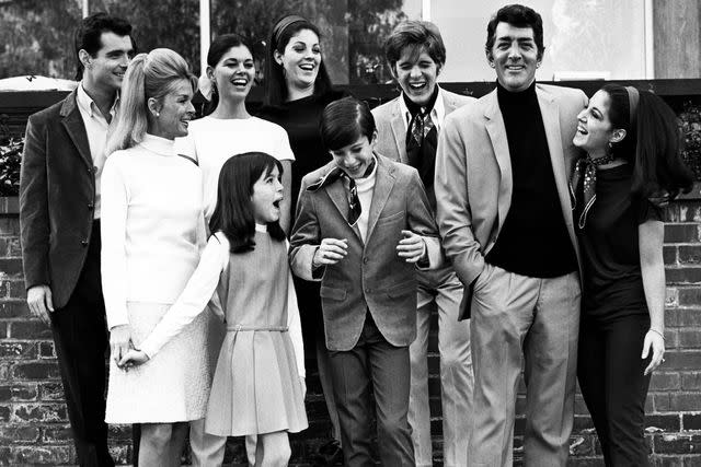 <p>Martin Mills/Getty</p> Craig Martin, Claudia Martin, Gail Martin, Dean-Paul Martin, Jeanne Martin, Gina Martin, Ricci Martin, Dean Martin, and Deana Martin pose for a family portrait circa 1966 at their home in Los Angeles, California.