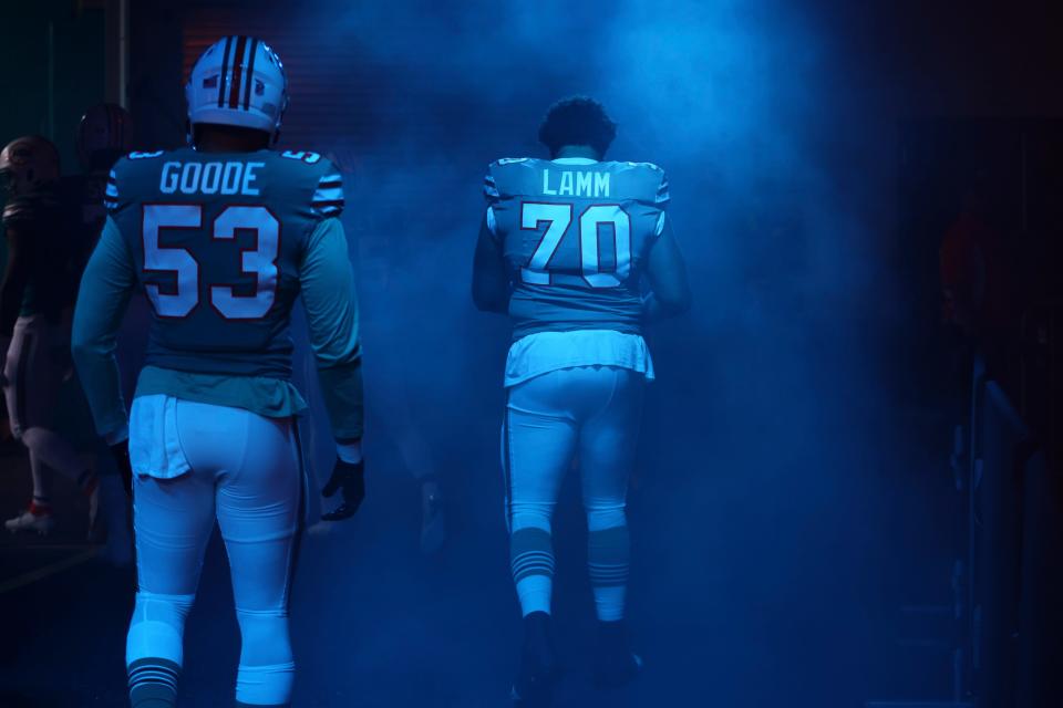 Dec 24, 2023; Miami Gardens, Florida, USA; Miami Dolphins offensive tackle Kendall Lamm (70) and linebacker Cameron Goode (53) walk toward the field prior to the game against the Dallas Cowboys at Hard Rock Stadium. Mandatory Credit: Sam Navarro-USA TODAY Sports