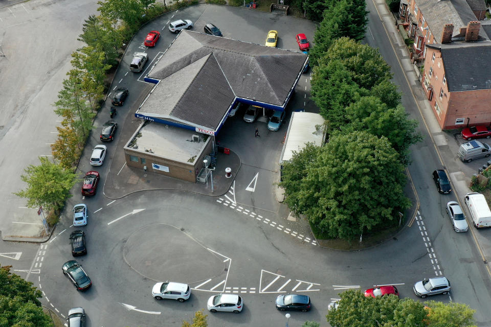 NORTHWICH, UNITED KINGDOM - SEPTEMBER 24: An aerial view of people queuing for petrol and diesel at a Tesco's Supermarket on September 24, 2021 in Northwich, United Kingdom. BP and Esso have announced that its ability to transport fuel from refineries to its branded petrol station forecourts is being impacted by the ongoing shortage of HGV drivers and as a result, it will be rationing deliveries to ensure continuity of supply. (Photo by Christopher Furlong/Getty Images)