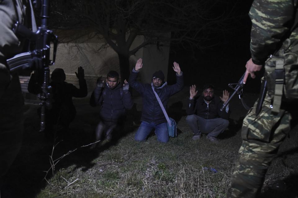 Greek Army arrest migrants in the village of Kastanies, Evros region, near the Greek-Turkish border on Friday, March 6, 2020. Thousands of refugees and other asylum-seekers have tried to enter Greece from the land and sea in the week since Turkey declared its previously guarded gateways to Europe open. (AP Photo/Giannis Papanikos)