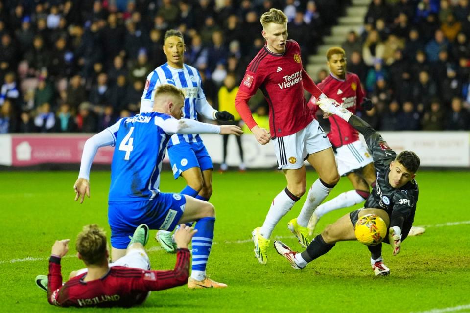 Wigan goalkeeper, Sam Tickle, had an impressive night to deny the likes of Marcus Rashford and Rasmus Hojlund (AP)