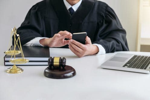   <span class="attribution"><a class="link " href="https://www.shutterstock.com/image-photo/male-lawyer-judge-working-smart-phone-741385033?src=rLnezd4pfqAqMnj77XtfqQ-1-32" rel="nofollow noopener" target="_blank" data-ylk="slk:Shutterstock;elm:context_link;itc:0;sec:content-canvas">Shutterstock</a></span>