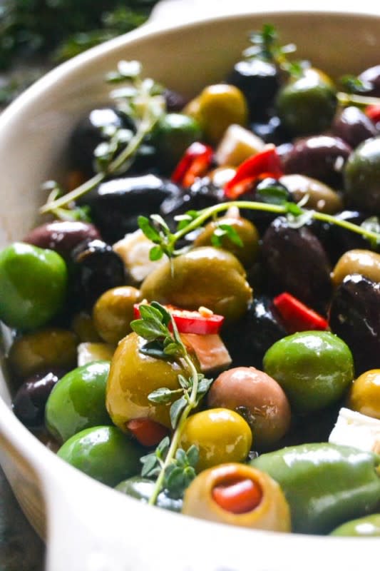<p>The View From Great Island</p><p>This recipe for Roasted Olives is an effortlessly elegant appetizer. When you roast olives they get softer and milder, and take on a melting texture that is a little unexpected. </p><p><strong>Get the recipe: <a href="http://theviewfromgreatisland.com/effortless-entertaining-roasted-olives/" rel="nofollow noopener" target="_blank" data-ylk="slk:Roasted Olives;elm:context_link;itc:0;sec:content-canvas" class="link rapid-noclick-resp">Roasted Olives</a></strong></p>