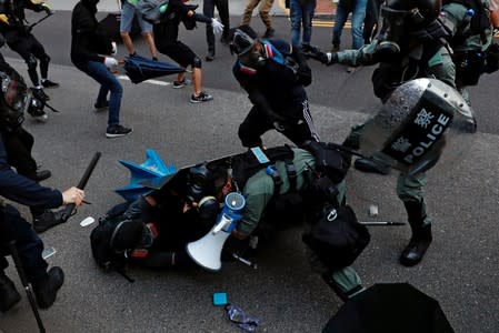 Anti-government protesters clash with riot police during a march at Tuen Mun, Hong Kong
