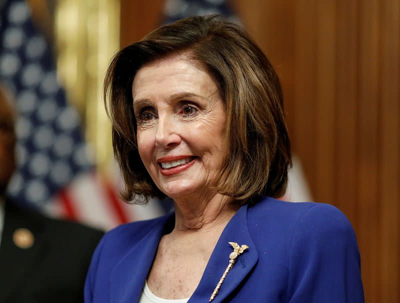 FILE PHOTO: House Speaker Pelosi holds coronavirus aid bill signing ceremony at the U.S. Capitol in Washington