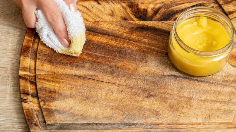 Applying beeswax to board