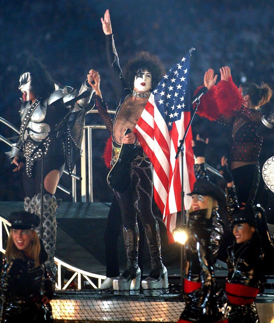 Gene Simons, left, and Paul Stanley of KISS, wave to the crowd after performing at the Salt Lake 2002 Winter Games closing ceremony at the University of Utah’s Rice-Eccles Stadium Sunday, Feb. 24, 2002. | Jeffrey D. Allred, Deseret News