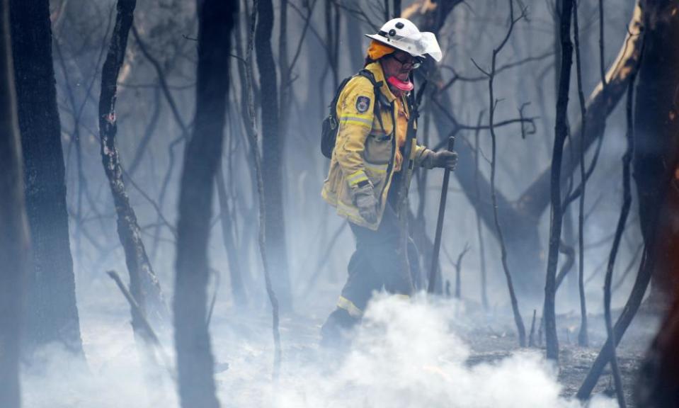 A firefighter mops up at South Turramurra