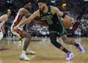 Boston Celtics forward Jayson Tatum (0) dribbles around Miami Heat forward Haywood Highsmith (24) during the first half of Game 4 of an NBA basketball first-round playoff series, Monday, April 29, 2024, in Miami. (AP Photo/Marta Lavandier)