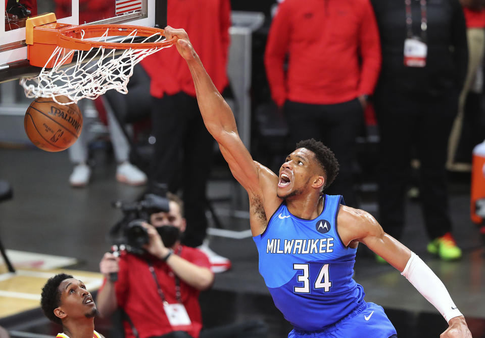 Milwaukee Bucks forward Giannis Antetokounmpo slams over Atlanta Hawks guard Lou Williams during the second quarter in Game 3 of the NBA Eastern Conference basketball finals, Sunday, June 27, 2021, in Atlanta. (Curtis Compton/Atlanta Journal-Constitution via AP)