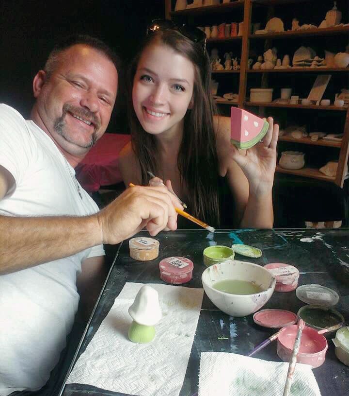 Rylee Black, right, shares a moment at the paint table with her father