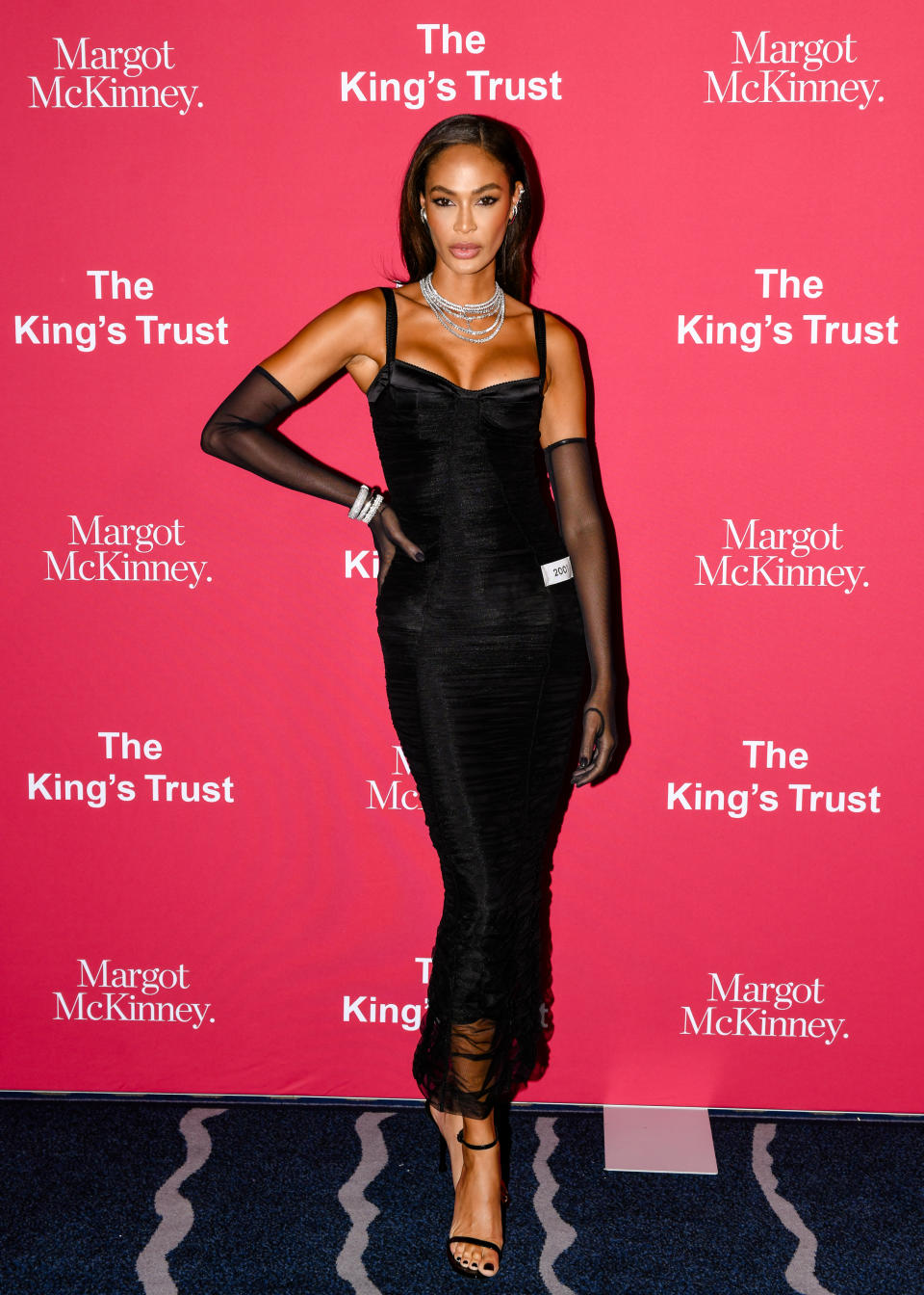 Joan Smalls attends The Global Trust Gala in black strappy stilettos