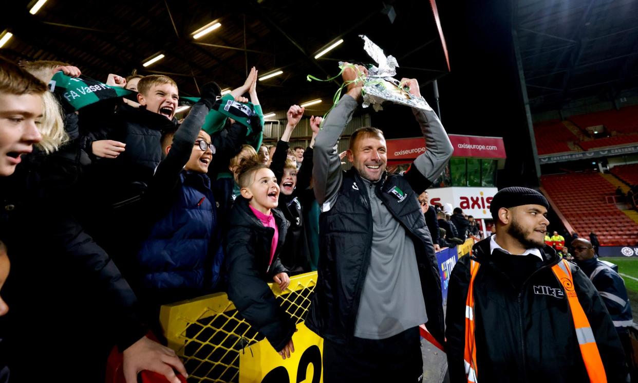 <span>The Cray Valley Paper Mills manager, Steve McKimm, celebrates with a replica FA Cup after his side drew at Charlton this season to earn a replay.</span><span>Photograph: Steven Paston/PA</span>