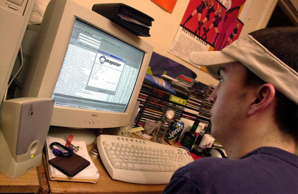 A New York University student downloads music from the Napster site March 6, 2001 in New York City. A federal judge has ordered Napster Inc. to block any copyright-protected songs from its service, giving the recording industry another victory.