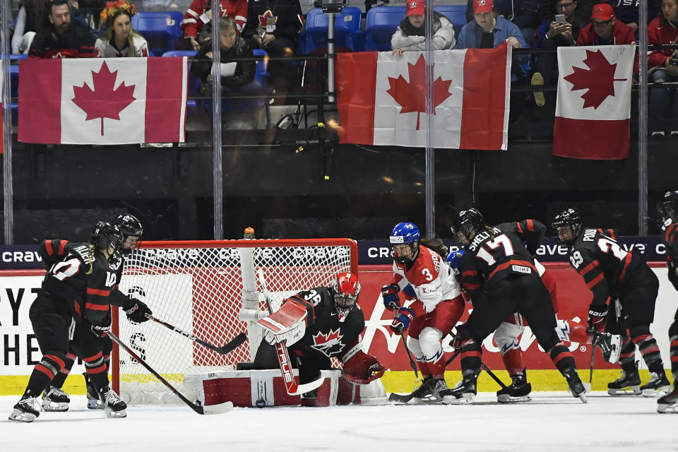 Canada goalie Ann-Renee Desbiens (35) makes a save against Czechia forward Adela Sapovalivova (3) during the first period of a semifinal at the women's world hockey championships in Utica, N.Y., Saturday, April 13, 2024. (AP Photo/Adrian Kraus)
