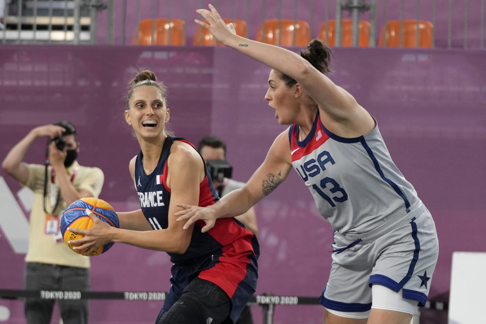 France's Ana Maria Filip (11) looks to pass as United States' Stefanie Dolson (13) defends during a women's 3-on-3 basketball game at the 2020 Summer Olympics, Saturday, July 24, 2021, in Tokyo, Japan. (AP Photo/Jeff Roberson)