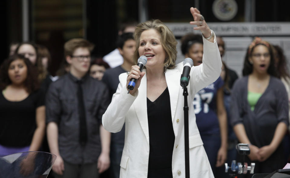 In this March 19, 2012 photo, famed soprano Renee Fleming performs with a choir of dozens of high school students in the rotunda of the State of Illinois building, the James R. Thompson Center, in Chicago. For the past school year the opera singer has been mentoring teenaged vocal students in Chicago as part of her role as creative consultant at the Lyric Opera of Chicago.(AP Photo/Kiichiro Sato)