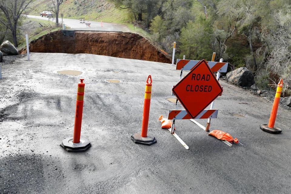 Signs block access to a section of Chimney Rock Road northwest of Paso Robles on Saturday, March 11, 2023. The road washed out during the latest atmospheric river storm to hit San Luis Obispo County, stranding at least 100 residents.