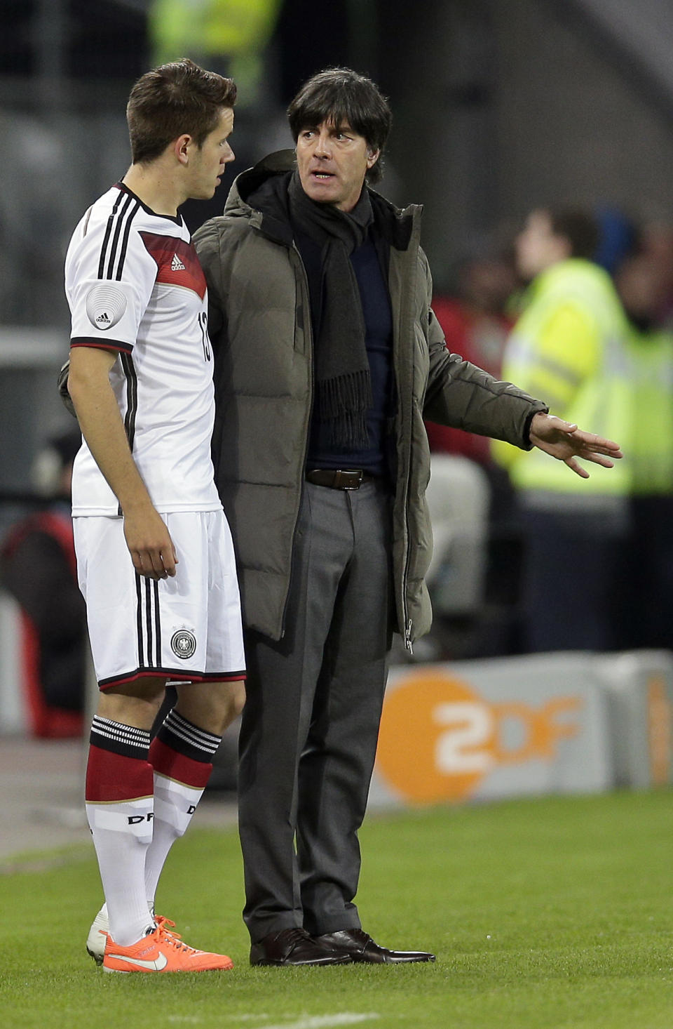 Germany's head coach Joachim Loew, right, talks to Germany's Christian Guenter, left, during a friendly soccer match between Germany and Poland in Hamburg, Germany, Tuesday, May 13, 2014. (AP Photo/Michael Sohn)